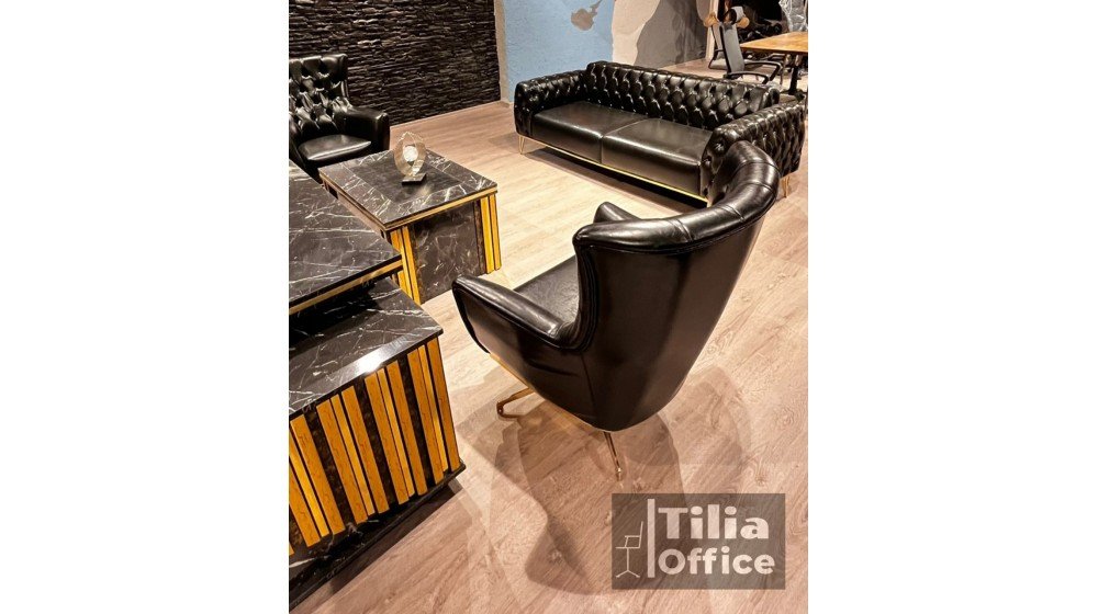 Gold lüks yönetici masa takımı, siyah mermer desenli tablası ve altın rengi dikey çıtalı panelleri ile ofis ortamında dönerli Chester ikili ve tekli koltuklar ile sergileniyor.